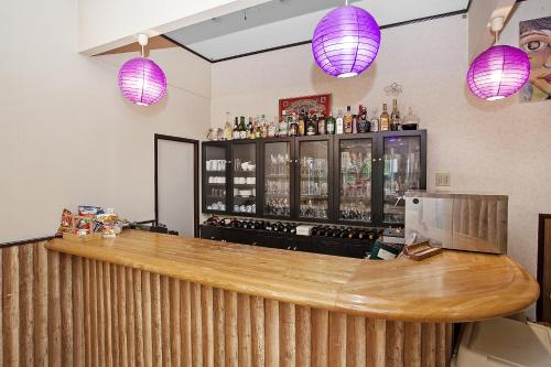a bar with purple lights above a counter at Tenjin Lodge in Minakami