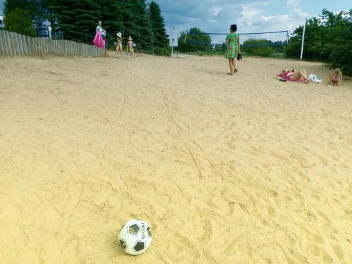 a soccer ball in the sand on a beach at Gilužio Rivjera in Vilnius