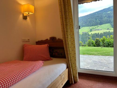 a room with a bed and a window with a view at Haus Schmetterling in Alpbach