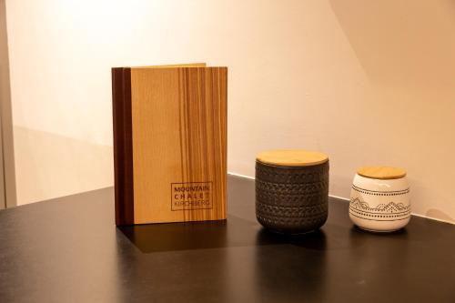 a table with a box and two vases on it at Mountain Chalet Kirchberg by Apartment Managers in Kirchberg in Tirol