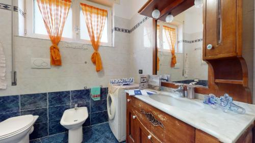a bathroom with a sink and a toilet and a mirror at House Antica Romana by Holiday World in Genoa