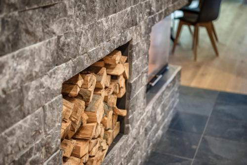 a stack of fire wood in a brick fireplace at Mountain Chalet Kirchberg by Apartment Managers in Kirchberg in Tirol