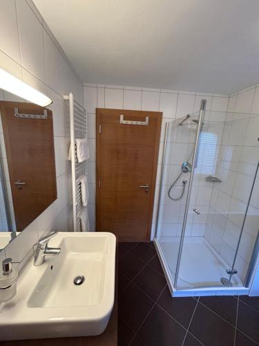 a bathroom with a sink and a shower at Haus Schmetterling in Alpbach