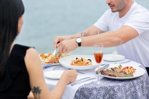 a group of people sitting at a table eating food at La Mer Resort Spa Crete in Georgioupolis