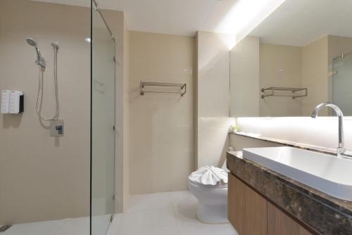 a bathroom with a shower and a toilet and a sink at VST Residence -SHA PLUS Certified in Ban Khlong Bang Ping