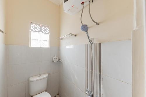 bagno bianco con doccia e servizi igienici di RedDoorz Syariah at Sudirman Street Garut a Garut