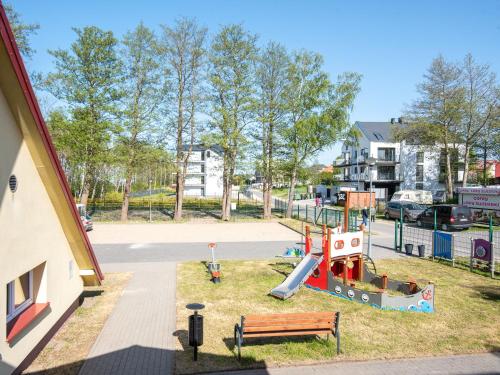 a playground with a slide in a park at Nad brzegiem Bałtyku in Sarbinowo