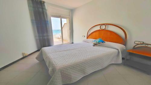a bedroom with a bed and a large window at Apartamento Costamar by VACAY L'Escala in L'Escala