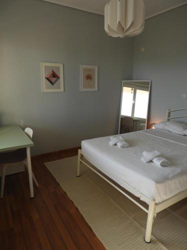 a bedroom with a bed and a mirror and a table at Letos Apartment Sky in Kavála