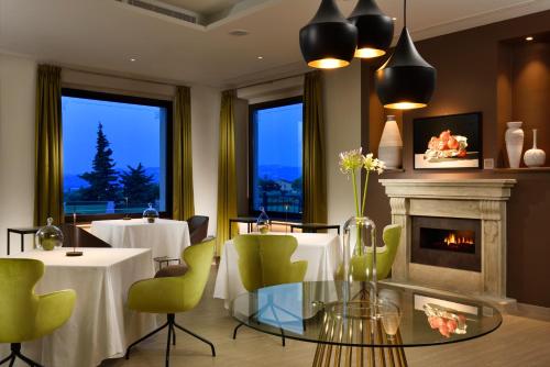 a dining room with two tables and a fireplace at Borgobrufa Spa Resort Adults Only in Brufa