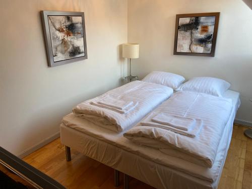 a bed with white sheets on it in a room at City Center Apartments 187 in Copenhagen