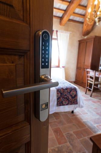 a remote control in a room with a bedroom at Locanda di Montegiove in Fano