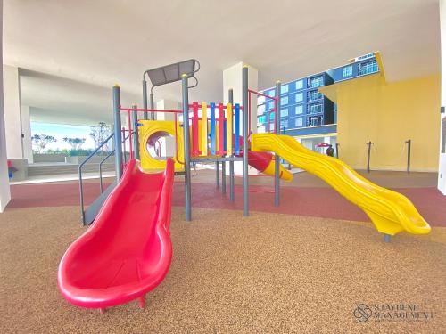 a playground with colorful slides in a building at Melaka Novo 8 Residence - Jonker Street by Stayrene in Melaka