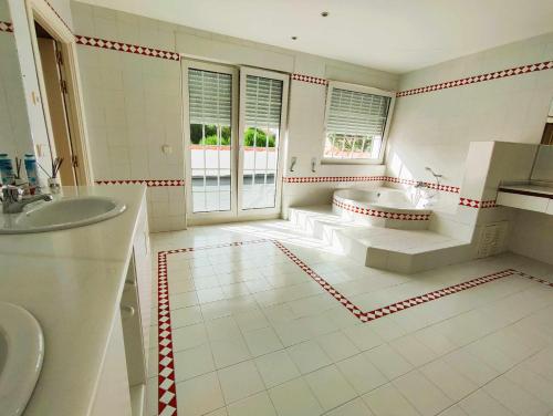 a large bathroom with a tub and a sink at La Casona Imperial in Alpedrete