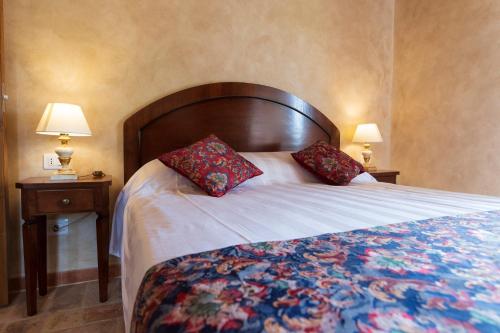 a bedroom with a large bed with two night stands at Locanda di Montegiove in Fano