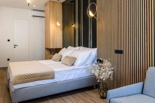a bedroom with a bed and a couch and a chair at Via Mare Luxury Rooms in Split