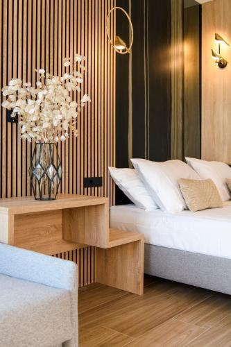 a bedroom with a bed and a table with a chandelier at Via Mare Luxury Rooms in Split