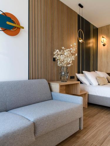 a living room with a couch and a bed at Via Mare Luxury Rooms in Split