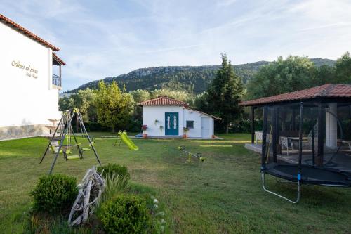 a yard with a playground and a house at Amo el mar Porto Koufo in Porto Koufo