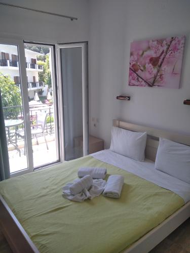 a bedroom with a large bed with towels on it at Oasis in Parga
