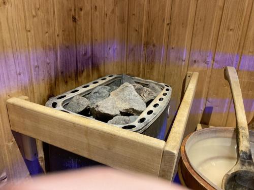 a tub full of rocks in a wooden wall at Royal Mediterran in Siófok