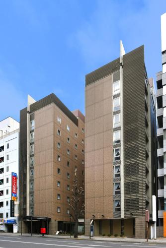 two tall buildings in a city with a street at Nagoya Sakae Washington Hotel Plaza in Nagoya