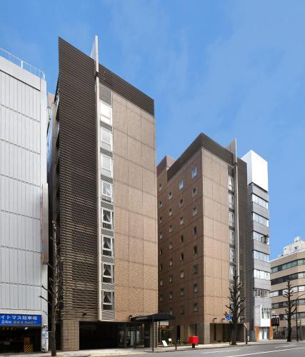 two tall buildings next to each other on a street at Nagoya Sakae Washington Hotel Plaza in Nagoya