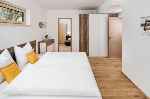 a bedroom with two large white beds in it at Appartement Irene in Caldaro
