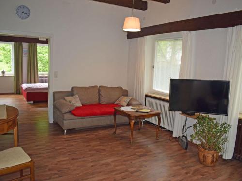 a living room with a couch and a flat screen tv at Kandelbleibe in Waldkirch