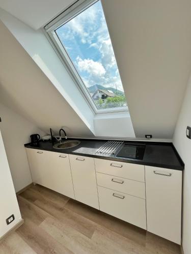 a kitchen with a sink and a window at Hiša Grilc in Kranjska Gora