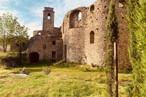 an old stone building with a tower on a field at One Step from Heaven by Holiday World in Baiardo