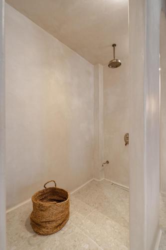 a wicker basket sitting on the floor of a room at Stoa Suites in Naxos Chora