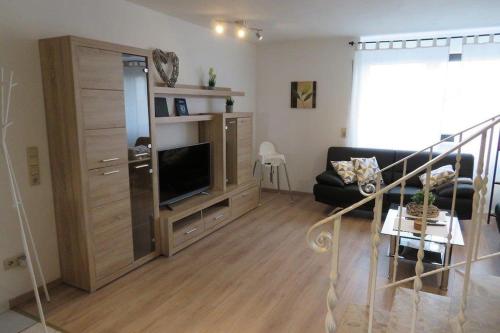 a living room with a couch and a tv at Ferienwohnung Scheer 