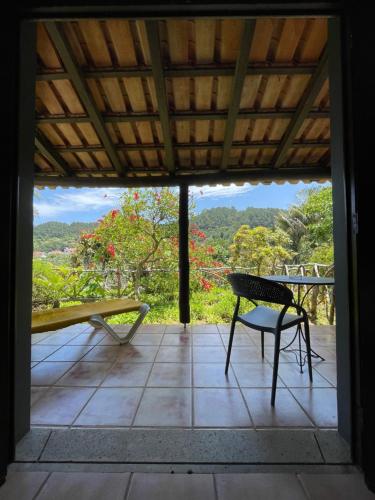 a patio with a table and a bench and a view at Casas de Campo do Pomar B&B - Self Check-in in Santana