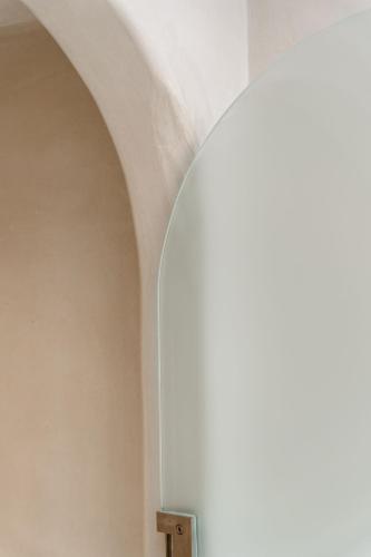 an archway in a room with a window at Stoa Suites in Naxos Chora