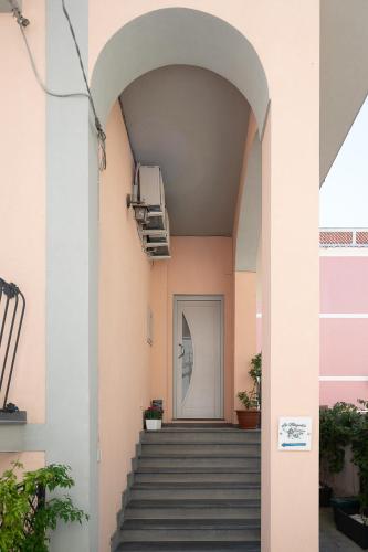 an archway leading up to a staircase in a building at La Magnolia Rooms in Procida