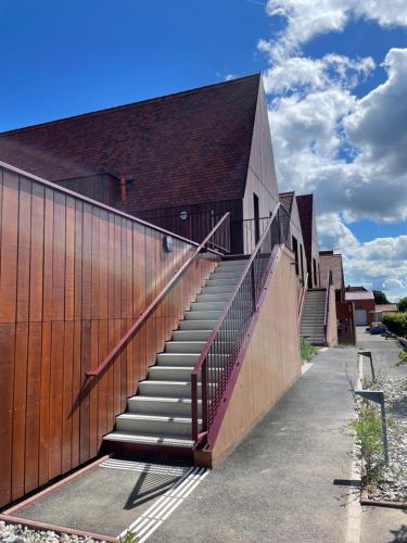 a building with stairs in front of a building at Appartements de Manon au cœur des vignes in Kientzheim