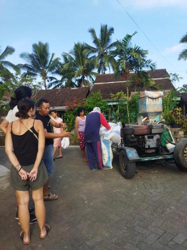 a group of people standing outside of a house at Nio Homestay and Tour in Licin