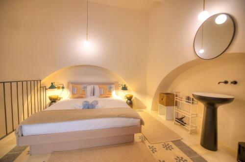 a bedroom with a bed and a sink in a room at Chic duplex maisonette in Valletta centre-DDEM4 in Valletta