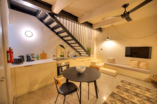 a kitchen and dining room with a table and chairs at Chic duplex maisonette in Valletta centre-DDEM4 in Valletta