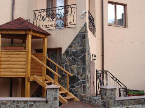 a building with a staircase and a gazebo at Glanz in Yaremche