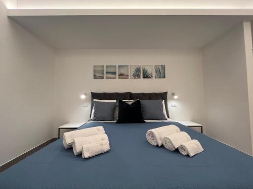 a bedroom with a blue bed with towels on it at La Casba in Paola