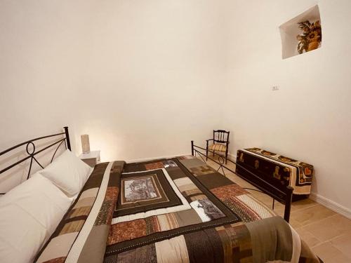 a bedroom with a bed with a table and a record player at Terra Rossa in Turi