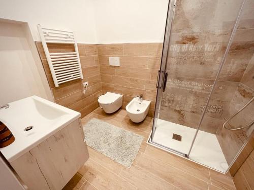 a bathroom with a shower and a toilet and a sink at Terra Rossa in Turi