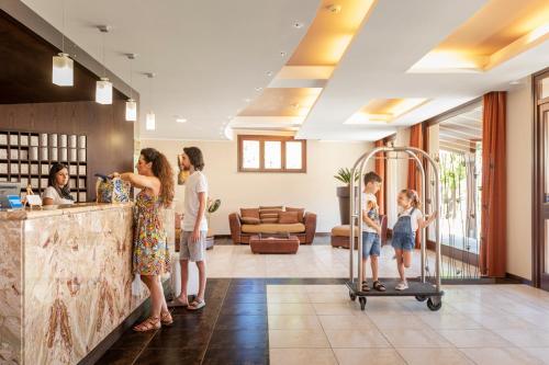 a group of people standing in a lobby at Villa Zina Family Resort in Custonaci