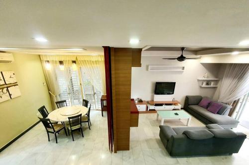 a living room with a couch and a table at GARDEN COZY2STOREY HOME 4ROOM 10PAX@NEAR ALMAJUSCO in Bukit Mertajam