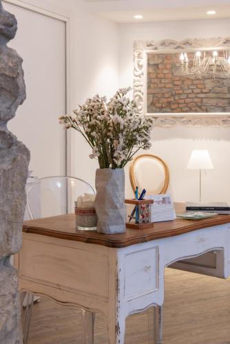 a table with a vase of flowers on top of it at Al San Lorenzo in Bergamo