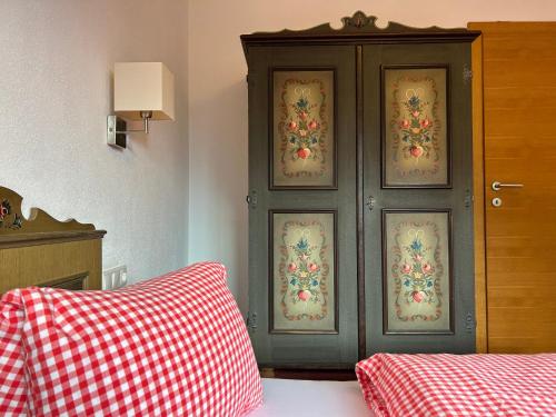 a black cabinet with christmas decorations on it in a bedroom at Haus Schmetterling in Alpbach