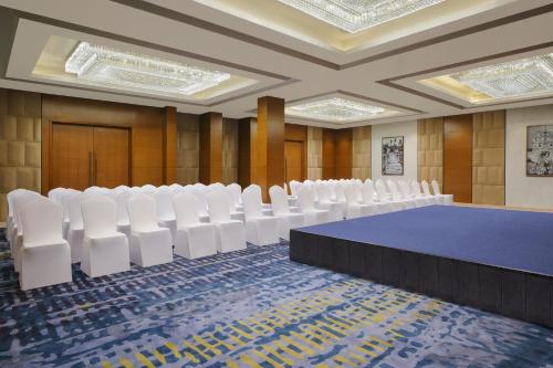 a conference room with a blue table and white chairs at Fairfield by Marriott Goa Calangute in Calangute