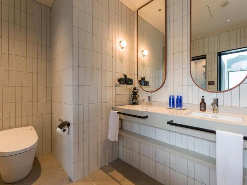 a bathroom with a toilet and a sink and a mirror at Rakuten STAY Atami in Atami